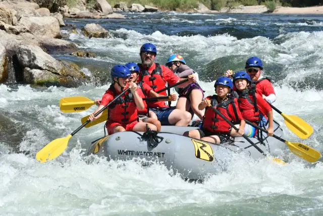 Troop 1513 Scouts paddling together through whitewater